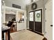 Bright foyer with high ceilings, dark wood floors, and glass door to office space at 10715 Hamilton Pass, Fishers, IN 46037