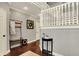 Spacious foyer with hardwood floors, coat rack, and staircase with white railing at 10715 Hamilton Pass, Fishers, IN 46037