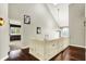 Bright upper hallway features hardwood floors, neutral walls, and views of the bedroom at 10715 Hamilton Pass, Fishers, IN 46037