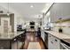 This open kitchen has stainless appliances, granite counters, gray cabinets and is open to the living room at 10715 Hamilton Pass, Fishers, IN 46037