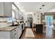 The kitchen features gray cabinets, stainless steel appliances, granite counters and a center island at 10715 Hamilton Pass, Fishers, IN 46037
