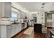 This kitchen features gray cabinets, stainless steel appliances, granite counters and a center island at 10715 Hamilton Pass, Fishers, IN 46037