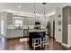 This kitchen features gray cabinets, stainless steel appliances, granite counters and a center island at 10715 Hamilton Pass, Fishers, IN 46037