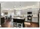 This kitchen features gray cabinets, stainless steel appliances, granite counters and a center island at 10715 Hamilton Pass, Fishers, IN 46037