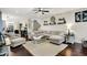 Bright living room featuring a sectional sofa, ceiling fan, and elegant decor at 10715 Hamilton Pass, Fishers, IN 46037