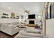 Cozy living room featuring a fireplace, large TV, and comfortable seating arrangement at 10715 Hamilton Pass, Fishers, IN 46037