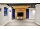Spacious living room with a wooden feature wall and entertainment center at 10715 Hamilton Pass, Fishers, IN 46037