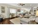 Open-concept living room with hardwood floors, large windows, and comfortable furnishings at 10715 Hamilton Pass, Fishers, IN 46037