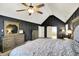 Main bedroom with vaulted ceiling, dark accent walls, and en-suite bathroom view at 10715 Hamilton Pass, Fishers, IN 46037