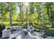 Spacious backyard with an outdoor kitchen, dining area and fire pit with Adirondack chairs at 10725 Holliday Farms Blvd, Zionsville, IN 46077