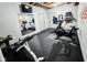 Finished basement featuring home gym with workout equipment, mirrored wall and exposed ceiling at 10725 Holliday Farms Blvd, Zionsville, IN 46077