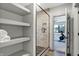This bathroom has floating shelves and a glass shower with gray tile and a black door handle at 10725 Holliday Farms Blvd, Zionsville, IN 46077