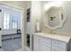 Bathroom featuring a white vanity with a marble countertop and unique mirror at 10725 Holliday Farms Blvd, Zionsville, IN 46077