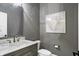 A modern half-bathroom featuring a marble countertop, stylish mirror, and gray painted walls at 10725 Holliday Farms Blvd, Zionsville, IN 46077