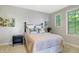 Well-lit bedroom featuring a comfortable bed, stylish decor, and a bright window at 10725 Holliday Farms Blvd, Zionsville, IN 46077
