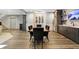 This dining area includes stainless steel appliances, a wine rack, a brick wall, and dark wood accents at 10725 Holliday Farms Blvd, Zionsville, IN 46077