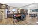 This dining area features a brick accent wall, stainless steel appliances, and sleek dark cabinetry at 10725 Holliday Farms Blvd, Zionsville, IN 46077