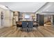 A dining area has stainless steel appliances, dark cabinets, a brick accent wall, and a TV mounted on the wall at 10725 Holliday Farms Blvd, Zionsville, IN 46077