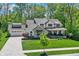 Beautiful two-story home with attached garage and a well-manicured lawn surrounded by trees at 10725 Holliday Farms Blvd, Zionsville, IN 46077