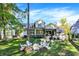 Stunning home exterior with manicured lawn and backyard fire pit and custom landscaping at 10725 Holliday Farms Blvd, Zionsville, IN 46077