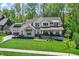 Charming two-story home with a beautifully landscaped lawn and a welcoming front porch at 10725 Holliday Farms Blvd, Zionsville, IN 46077