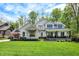 Stunning two-story home featuring stone accents and a lush green lawn under a bright sky at 10725 Holliday Farms Blvd, Zionsville, IN 46077