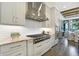 A bright kitchen with stainless steel appliances, white cabinetry, and a subway tile backsplash at 10725 Holliday Farms Blvd, Zionsville, IN 46077
