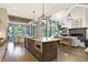 Modern kitchen with a large island, stainless steel appliances, and open layout to the living room at 10725 Holliday Farms Blvd, Zionsville, IN 46077