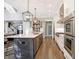 A spacious kitchen featuring a large island, stainless steel appliances, and modern lighting fixtures at 10725 Holliday Farms Blvd, Zionsville, IN 46077