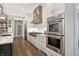 Well-lit kitchen showcasing stainless steel appliances, white cabinetry, and modern design elements at 10725 Holliday Farms Blvd, Zionsville, IN 46077