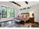 A bedroom with a large bed, ample natural light, and hardwood floors at 10725 Holliday Farms Blvd, Zionsville, IN 46077