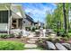 Beautiful outdoor seating area with a built-in grill and lush landscaping, perfect for relaxing or entertaining at 10725 Holliday Farms Blvd, Zionsville, IN 46077