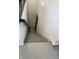 Finished basement staircase with gray painted steps and white walls with recessed lighting at 10725 Holliday Farms Blvd, Zionsville, IN 46077