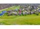 Aerial image of the house positioned near a golf course with a pond in a verdant, peaceful neighborhood at 10911 Innisbrooke Ln, Fishers, IN 46037