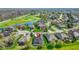Aerial view of a community with a house nestled between a golf course and a serene pond at 10911 Innisbrooke Ln, Fishers, IN 46037