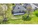 An aerial view of the home and backyard features a lush green lawn and a brick home at 10911 Innisbrooke Ln, Fishers, IN 46037