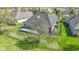 Aerial shot of a home's backyard featuring a white porch and manicured landscape with an expansive lawn at 10911 Innisbrooke Ln, Fishers, IN 46037