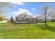 A backyard with a well-manicured lawn features a brick home and an outdoor patio at 10911 Innisbrooke Ln, Fishers, IN 46037