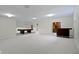 Open basement area with light-colored carpet, billiard table, bar, and access to additional rooms at 10911 Innisbrooke Ln, Fishers, IN 46037