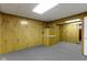Finished basement area with wood paneling and neutral carpeting, ready for personalization at 10911 Innisbrooke Ln, Fishers, IN 46037