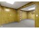 Finished basement space with wood paneling, neutral carpet, offering versatile potential at 10911 Innisbrooke Ln, Fishers, IN 46037