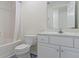 Bright bathroom featuring a white vanity with a sink, toilet, and tub-shower with a white shower curtain at 10911 Innisbrooke Ln, Fishers, IN 46037