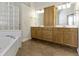Bathroom featuring a double vanity, soaking tub, and walk-in shower at 10911 Innisbrooke Ln, Fishers, IN 46037