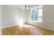 Bright dining room with natural light, hardwood floors, elegant chandelier, and wainscoting at 10911 Innisbrooke Ln, Fishers, IN 46037