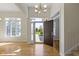 Bright foyer with hardwood floors, large windows providing natural light, and an open doorway at 10911 Innisbrooke Ln, Fishers, IN 46037