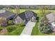Beautiful brick home with lush green lawn and landscape, featuring a spacious driveway and well-kept garden at 10911 Innisbrooke Ln, Fishers, IN 46037