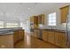 Well-lit kitchen with stainless steel appliances, light wood cabinets, and hardwood floors for a modern touch at 10911 Innisbrooke Ln, Fishers, IN 46037