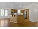 Open kitchen with wood island, stainless steel appliances, and large windows at 10911 Innisbrooke Ln, Fishers, IN 46037