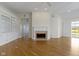 Spacious living room with fireplace, built-in shelving, and hardwood floors at 10911 Innisbrooke Ln, Fishers, IN 46037