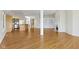 Open-concept living space with hardwood floors and views into kitchen at 10911 Innisbrooke Ln, Fishers, IN 46037